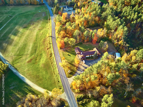 Scenic highway at autumn in New Hampshire, USA. Fall in New England. Aerial drone shot.