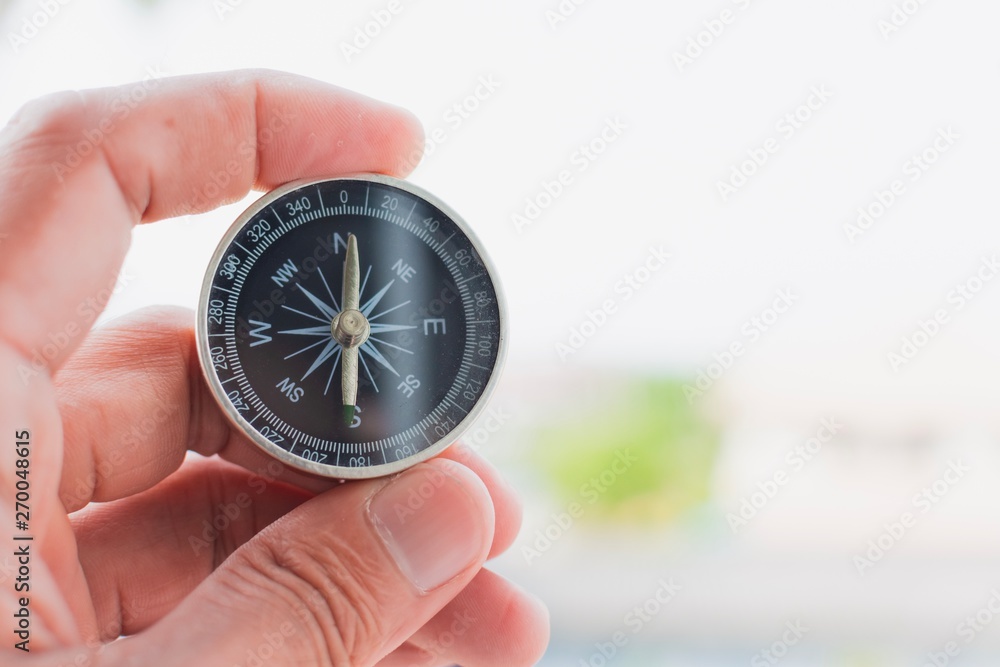 man holding compass on blurred background. for activity lifestyle man holding compass on blurred background. for activity lifestyle