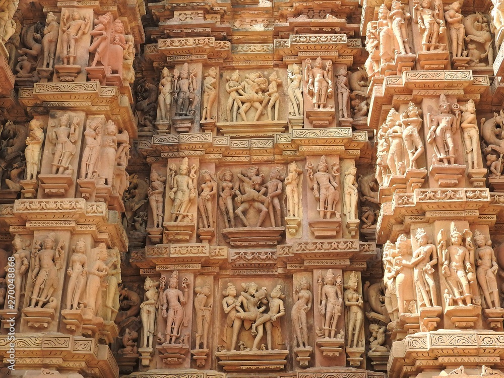 Close up of artful carved walls of Kandariya Mahadeva Temple, Khajuraho Group of Monuments, India.