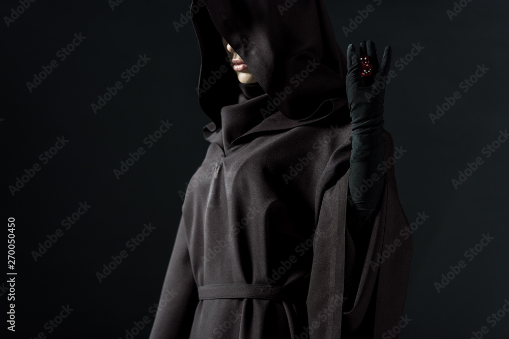 cropped view of woman in death costume holding dice isolated on black cropped view of woman in death costume holding dice isolated on black