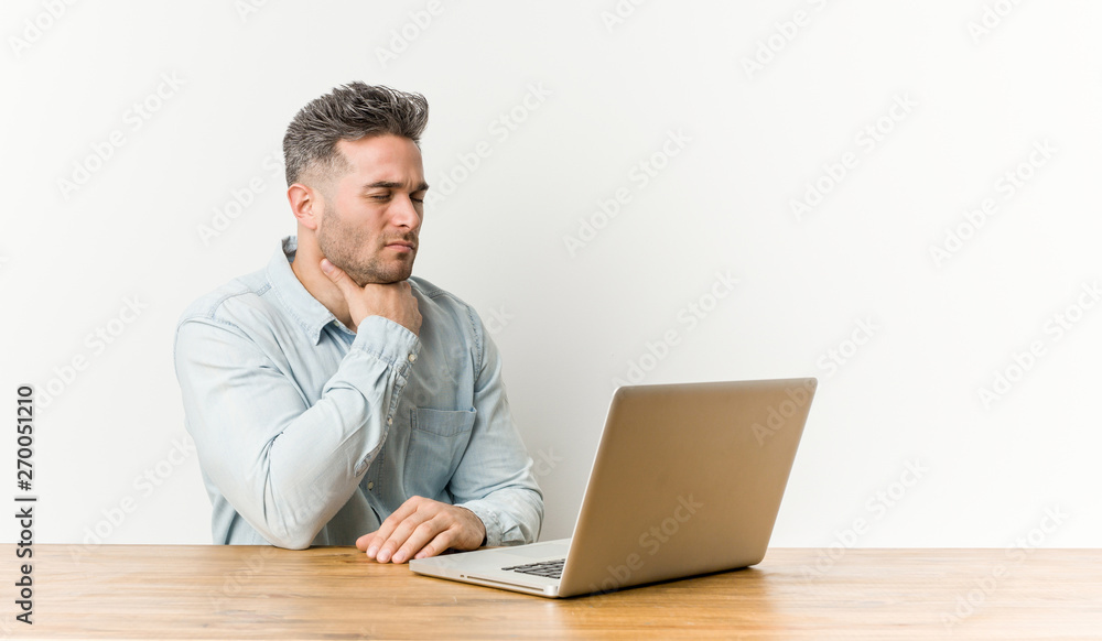 Young handsome man working with his laptop suffers pain in throat due a virus or infection. Young handsome man working with his laptop suffers pain in throat due a virus or infection.
