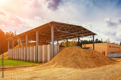 storage for wood chips in the street under a canopy. Sunflare