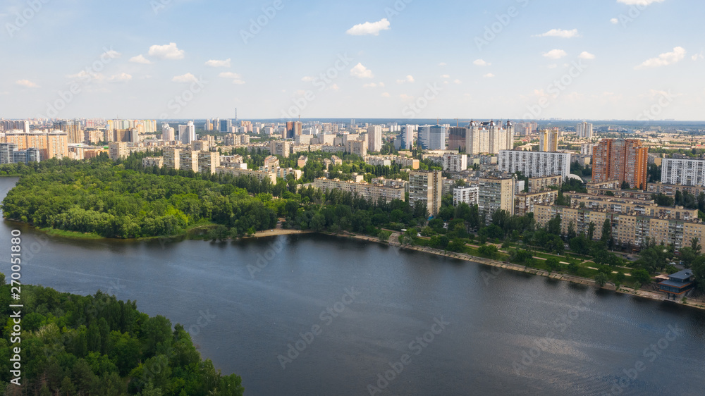 Aerial top view from drone on cityscape, skyline and coastline of Dnieper River near Rusanivka island at summer time. (Kyiv, Kiev) Ukraine.