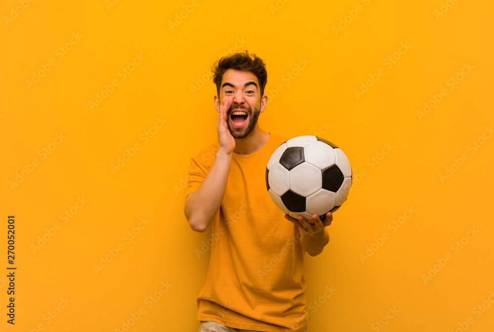Young soccer player man shouting something happy to the front Young soccer player man shouting something happy to the front