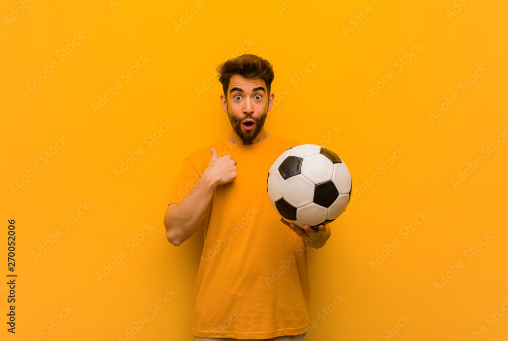 Young soccer player man surprised, feels successful and prosperous Young soccer player man surprised, feels successful and prosperous
