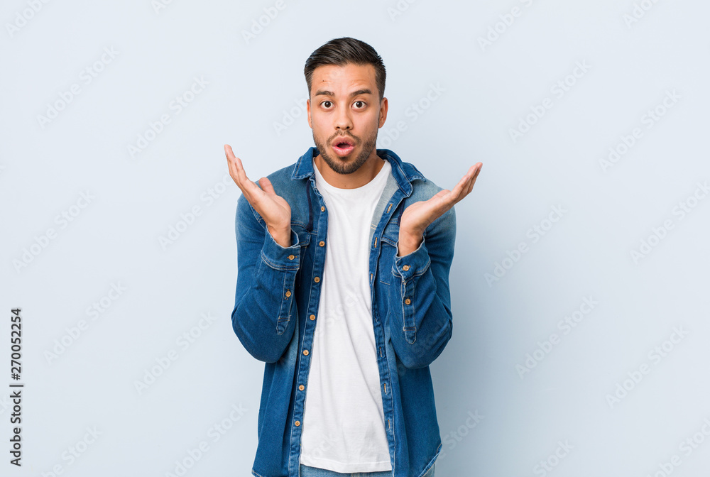 Young handsome filipino man surprised and shocked. Young handsome filipino man surprised and shocked.