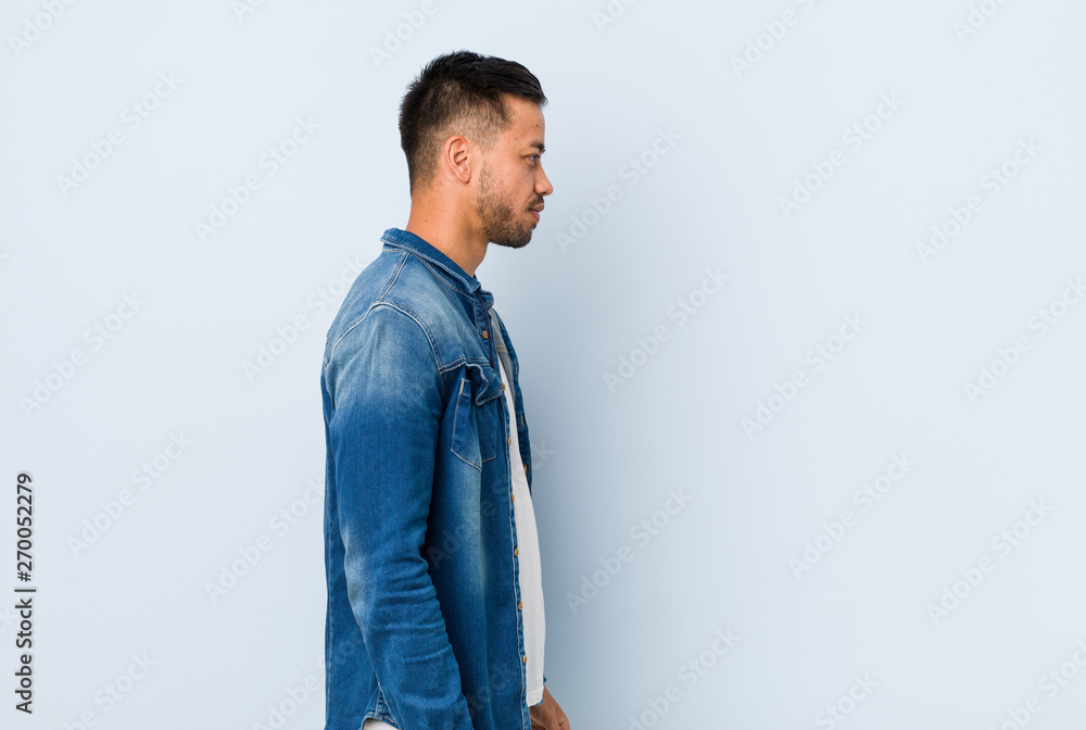 Fototapeta premium Young handsome filipino man gazing left, sideways pose.