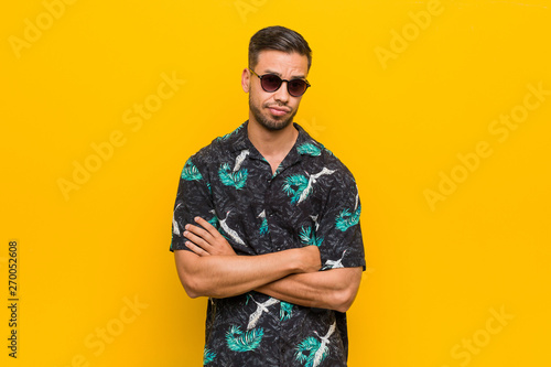 Young filipino man wearing summer clothes unhappy looking in camera with sarcastic expression.