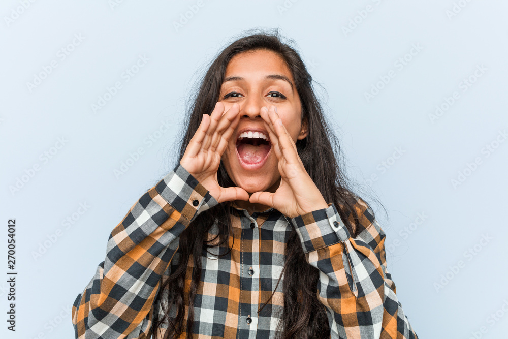 Young cool indian woman shouting excited to front. Young cool indian woman shouting excited to front.