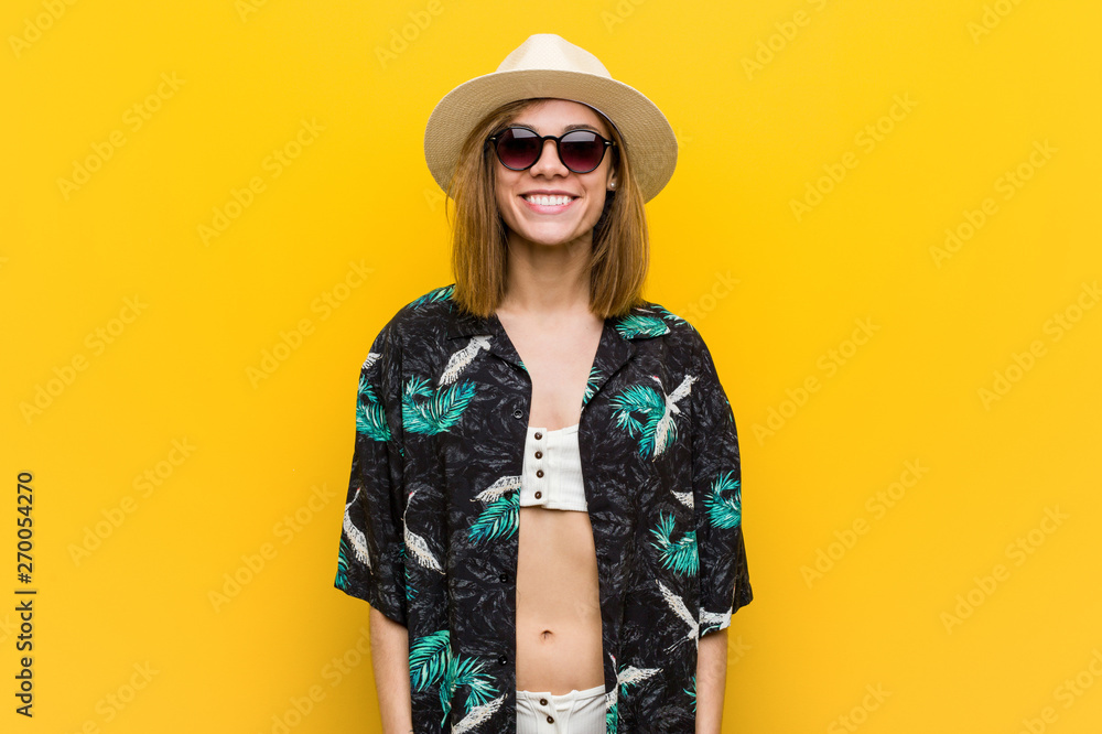 Young pretty woman wearing a hawaiian shirt very happy over yellow background. Young pretty woman wearing a hawaiian shirt very happy over yellow background.