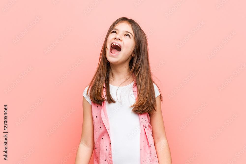 Cute little girl relaxed and happy laughing, neck stretched showing teeth. Cute little girl relaxed and happy laughing, neck stretched showing teeth.