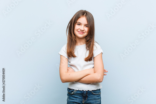 Cute girl who feels confident, crossing arms with determination.