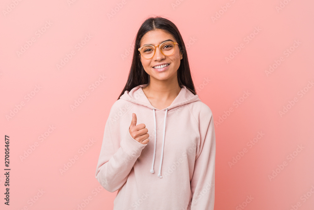 Fototapeta premium Young pretty arab woman wearing a casual sport look smiling and raising thumb up