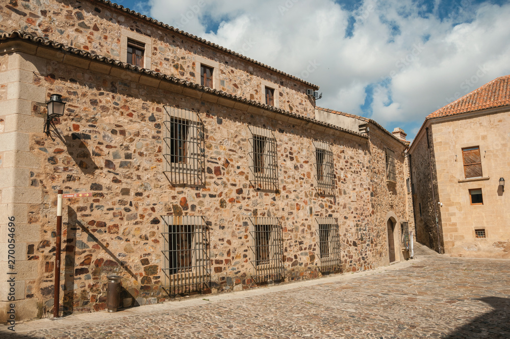Medieval buildings, with wooden door and barred windows at Caceres