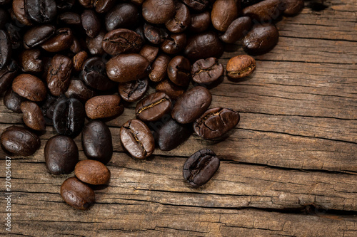 Roasted coffee beans on old wooden floors