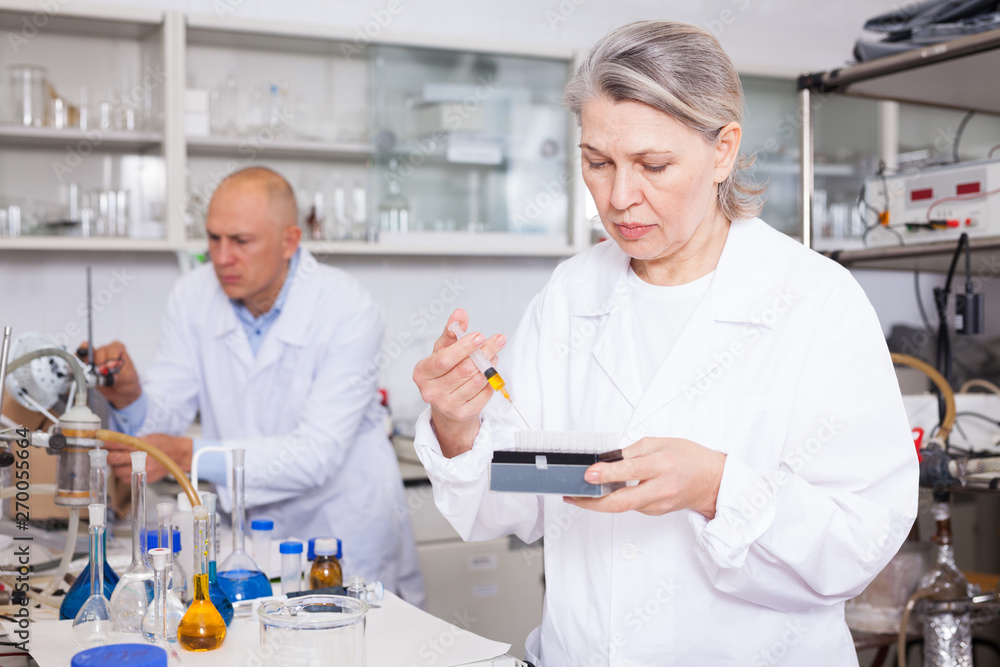 Female scientist working with reagents
