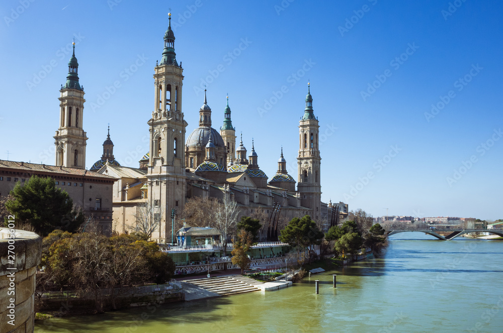 Zaragoza, Aragon, Spain - February 14th, 2019 : Basilica of Our Lady of the Pillar by the river Ebro. It is reputed to be the first church dedicated to Mary in history.