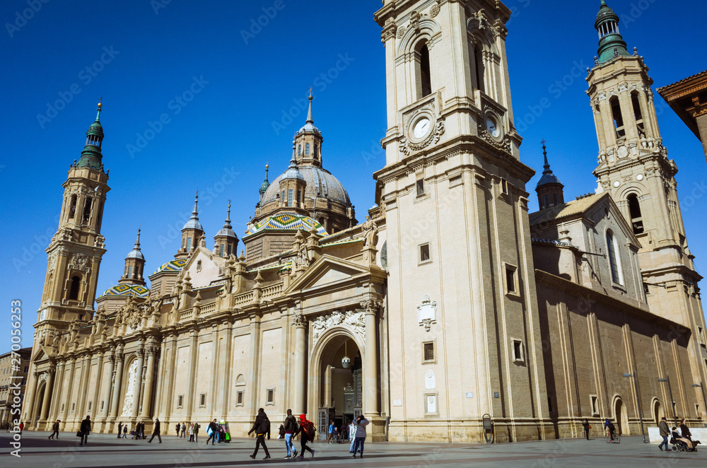 Zaragoza, Aragon, Spain, 2019 : Basilica of Our Lady of the Pillar at  Plaza del Pilar square. It is reputed to be the first church dedicated to Mary in history. Incidental people in background.