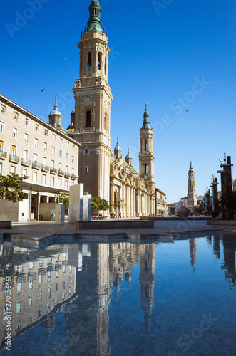 Zaragoza, Aragon, Spain, 2019 : Bell towers of Our Lady of the Pillar basilica reflected on the (Fountain of Hispanicity) at the Plaza del Pilar square. 
