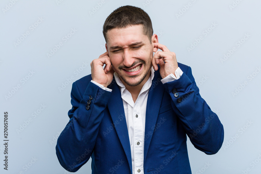 Young business caucasian man covering ears with his hands. Young business caucasian man covering ears with his hands.