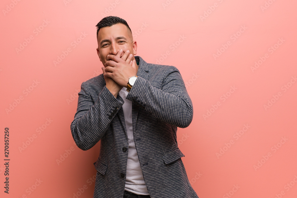 Young elegant latin man laughing about something, covering mouth with hands Young elegant latin man laughing about something, covering mouth with hands