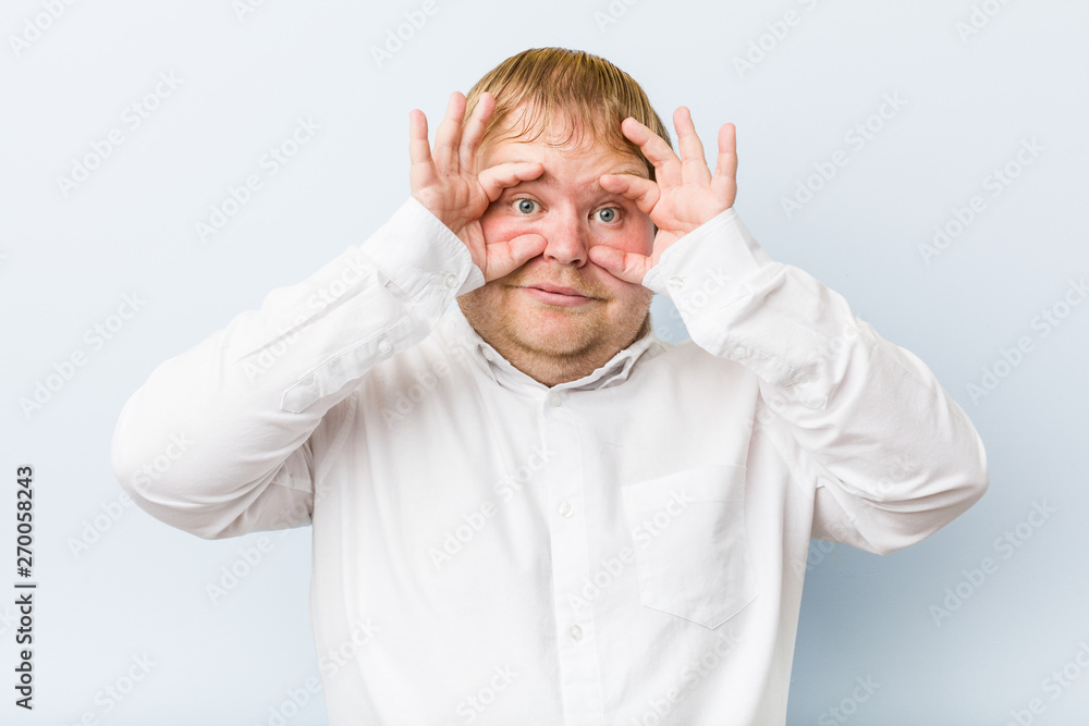 Young authentic redhead fat man showing okay sign over eyes Young authentic redhead fat man showing okay sign over eyes