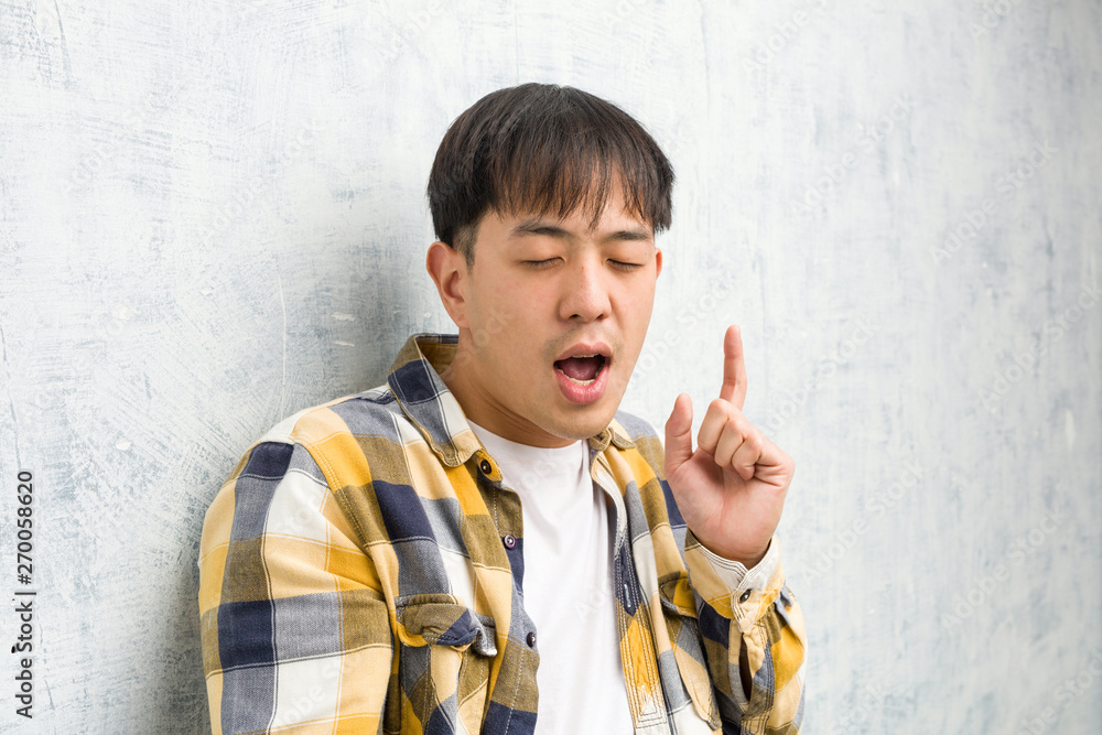 Young chinese man face closeup dancing and having fun Young chinese man face closeup dancing and having fun