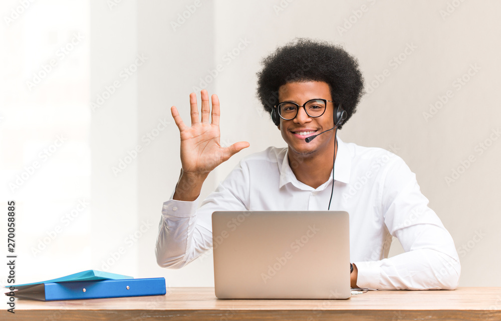 Young telemarketer black man showing number five Young telemarketer black man showing number five