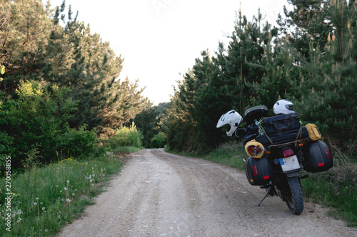 tourist motorcycle with side bags. enduro advetnture, space for text, summer day. Adventure expedition, explore, dirt road, offroad.