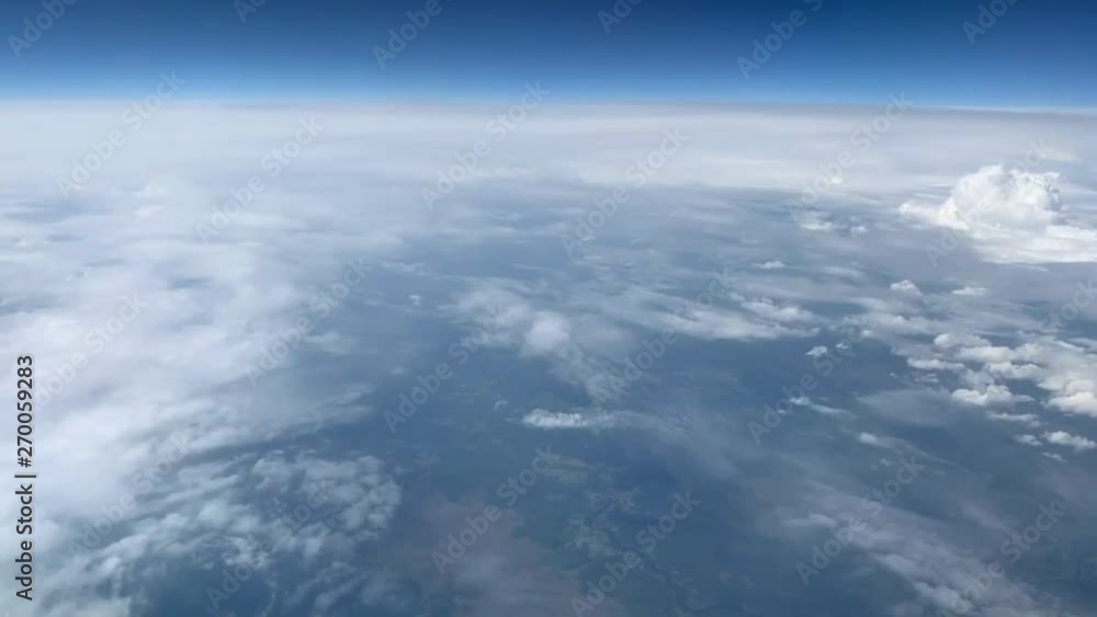 Airplane flight. Flying above the clouds. View from the window of the plane. Traveling by air Airplane flight. Flying above the clouds. View from the window of the plane. Traveling by air