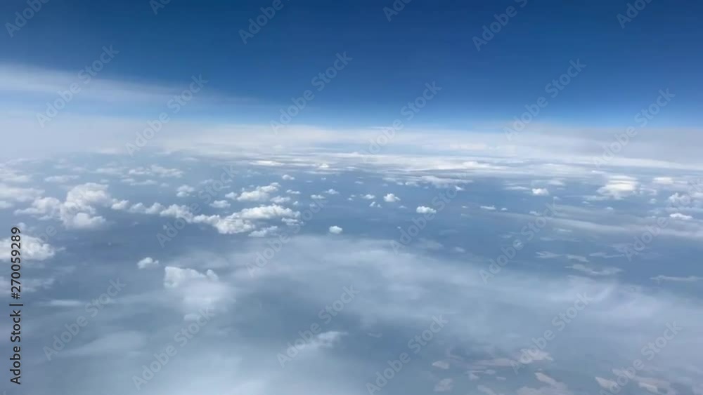 Airplane flight. Flying above the clouds. View from the window of the plane. Traveling by air Airplane flight. Flying above the clouds. View from the window of the plane. Traveling by air