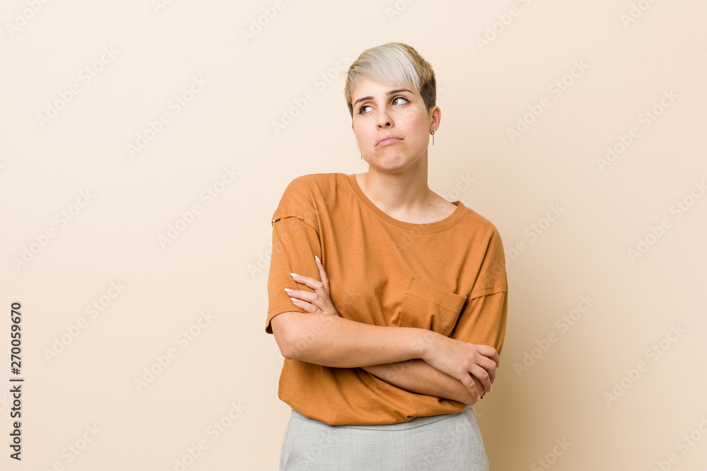 Obraz premium Young plus size woman with short hair tired of a repetitive task.