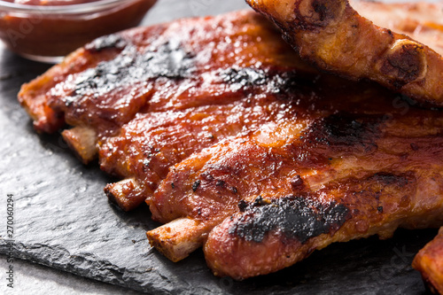 Grilled barbecue ribs on gray stone background