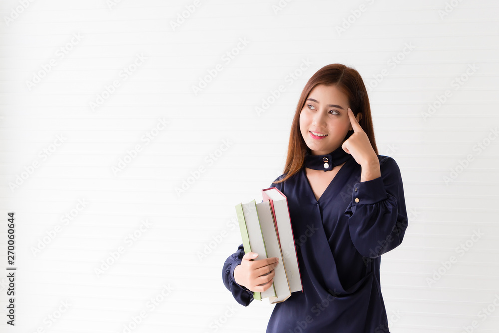 Young women, graduate students holding books are thinking about the future of work. Career and progress in her work Young women, graduate students holding books are thinking about the future of work. Career and progress in her work