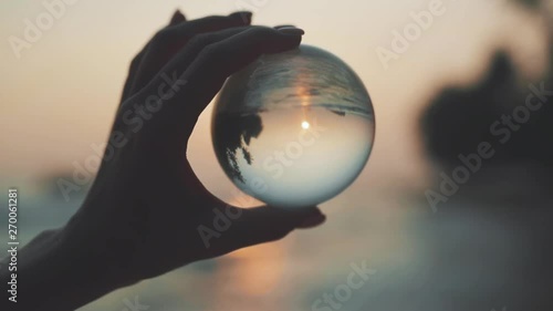 Woman hand with prism at beach