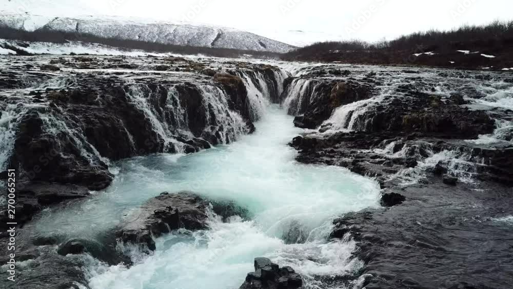 Arial view of Bruarfoss Waterfall in Iceland by far has the most blue water of all the waterfalls on the Golden Circle. Arial view of Bruarfoss Waterfall in Iceland by far has the most blue water of all the waterfalls on the Golden Circle.