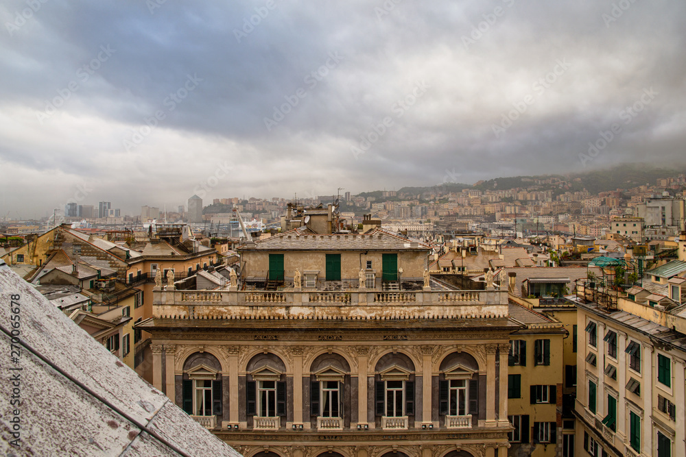 Panoramic view of Genoa rooftops taken from the top of the Cathedral of St Lawrence with Bendinelli Sauli palace (16th c., System of Rolli), in a rainy day with a dramatic cloudy sky, Liguria, Italy