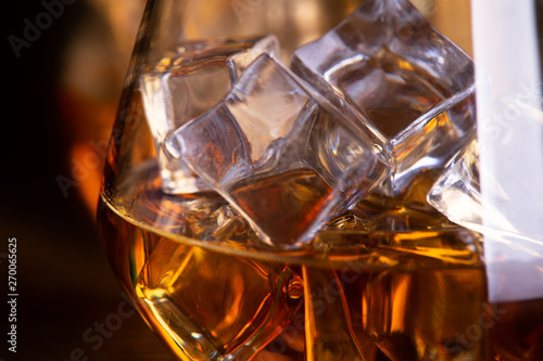 a glass of whiskey on wooden table