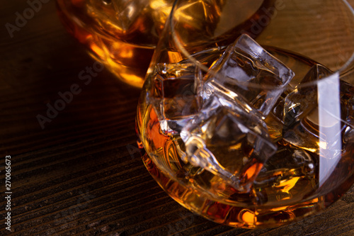 a glass of whiskey on wooden table
