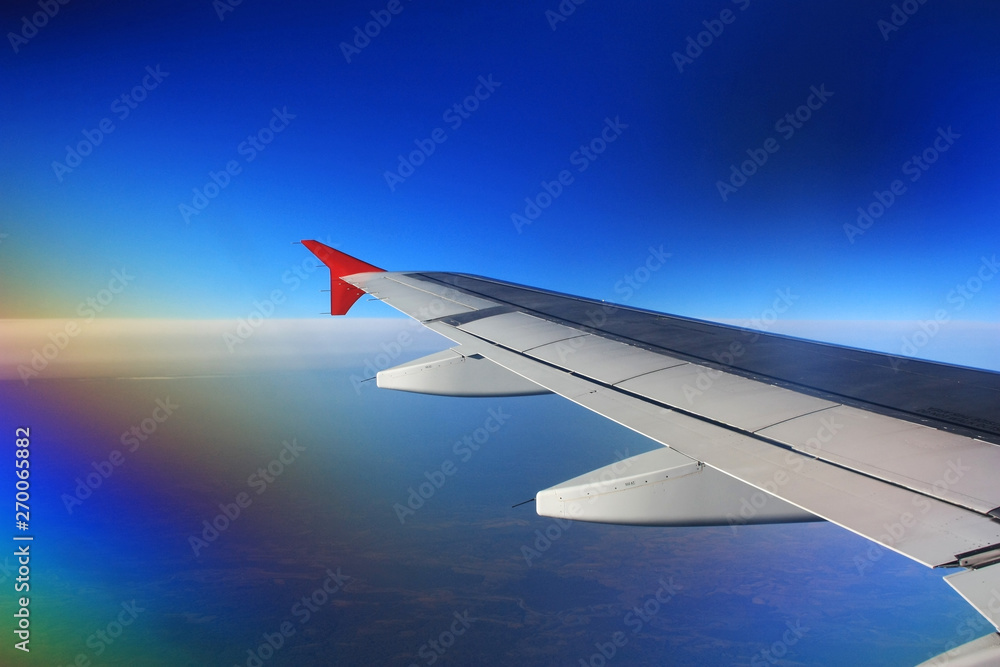 Airplane wing in the blue sky Airplane wing in the blue sky