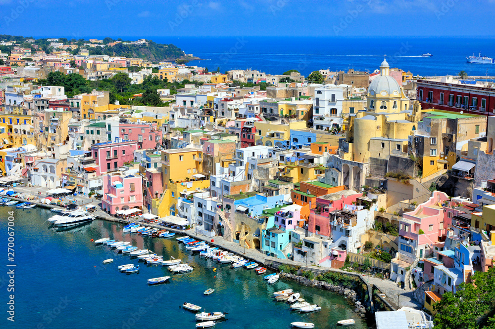 Beautiful island town in Italy. Aerial view overlooking the harbor and colorful pastel buildings of Procida.