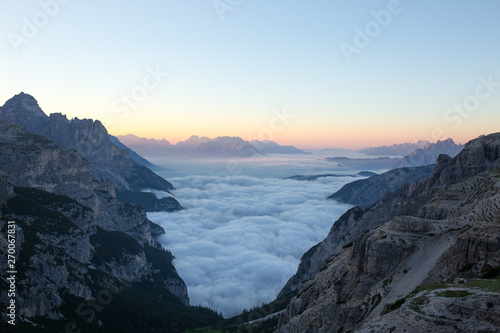 Valley full of clouds with an amazing view of the sunrise, italy