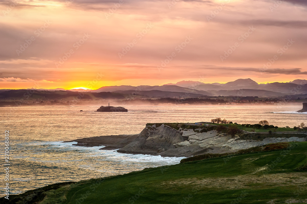 Sunrise in Cabo Mayor park. With a view of island with Mouro lighthouse in Santander, Cantabria, North Spain.