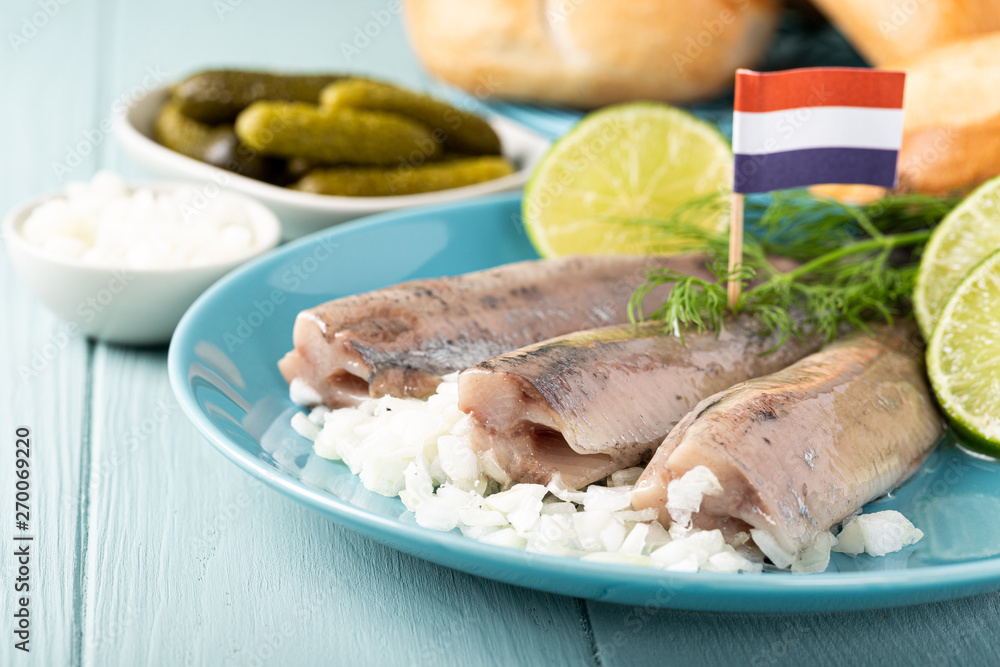 Traditional dutch food freshly salted herring fish with onion called hollandse nieuwe. European food concept with copy space. Traditional dutch food freshly salted herring fish with onion called hollandse nieuwe. European food concept with copy space.