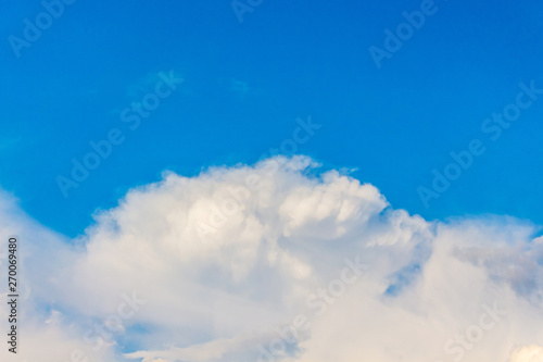 A white curly cloud on a blue sky_