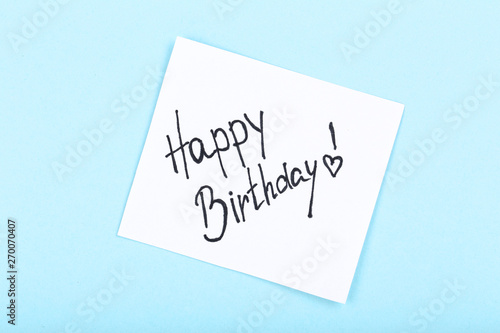 Paper with text Happy Birthday on blue background