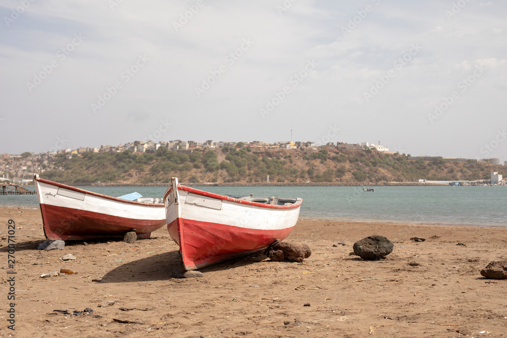 Red fisherman boats on the city beach of Praia, Santiago island, Cape Verde, Cabo Verde.