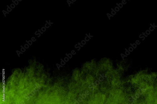 The movement of abstract dust explosion frozen green on black background. Stop the movement of powdered green on black background. Explosive powder green on black background.