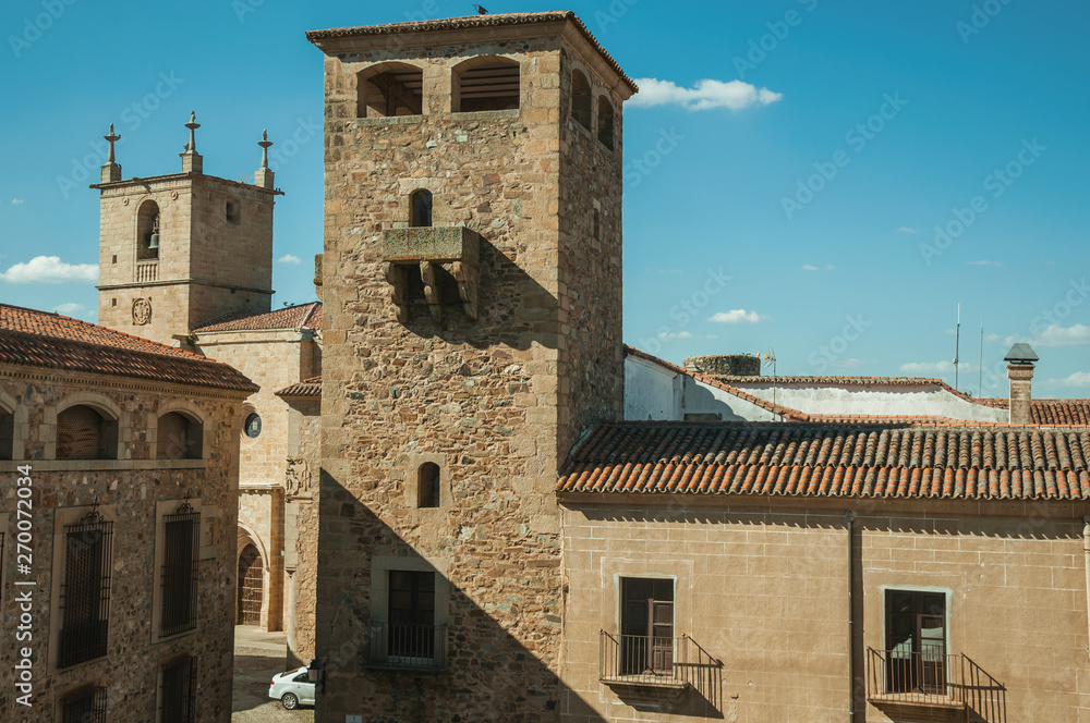 Stone tower and gothic steeple church at Caceres