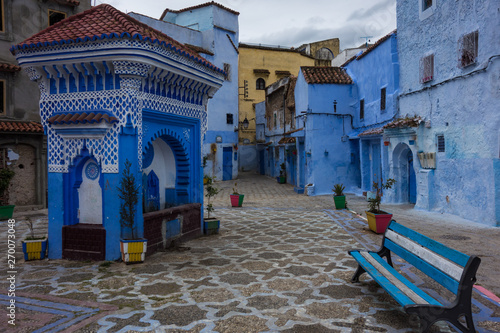 Traditional moroccan architectural details on a square with water well in the Blue City, Chefchaouen, Morocco © rutkowskii